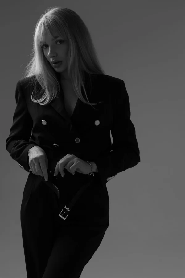[GENERATE: stark minimalist black and white fashion editorial, negative space, tailoring details, architectural framing]